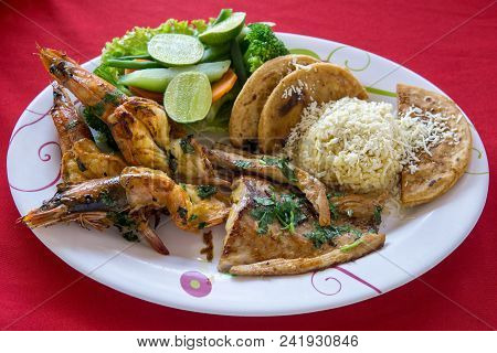 A Variety Of Seafood Grill On A Large Platter. King Prawns, Crab Langoustines And Fish With Torillas