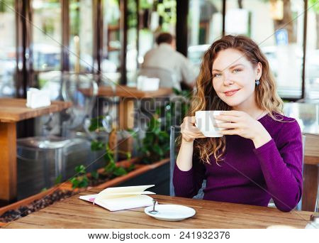 Beautiful Attractive Young Blonde Woman With Curly Hair Drinking Cappuccino And Eating Croissant In 