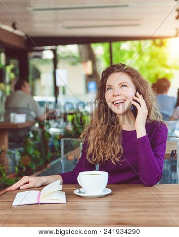 Beautifl Attractive Young Blonde Woman With Curly Hair Drinking Cappuccino And Talking On Telephone 