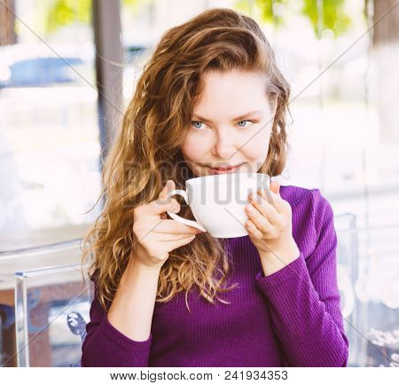 Beautifl Attractive Young Blonde Woman With Curly Hair Drinking Cappuccino In City Cafe Summer Day. 