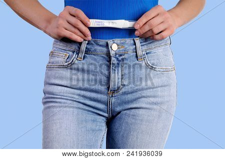 Pregnant Test. Woman Holdinj A Positive Pregnancy Test