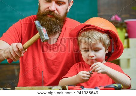 Masculine Duties Concept. Father, Parent With Beard Teaching Little Son To Use Hobnails And Hammer. 