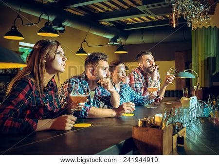 Sport, People, Leisure, Friendship, Entertainment Concept - Happy Male And Female Football Fans Or G