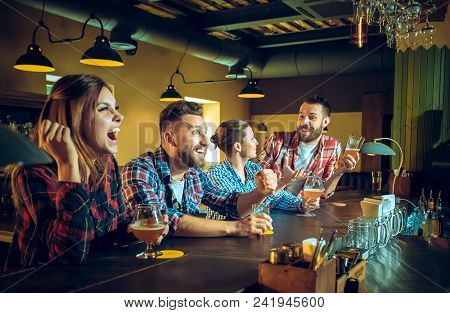 Sport, People, Leisure, Friendship, Entertainment Concept - Happy Male And Female Football Fans Or G