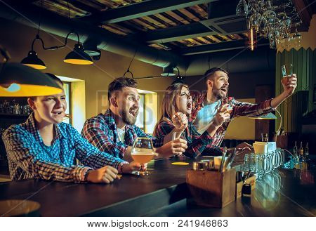 Sport, People, Leisure, Friendship, Entertainment Concept - Happy Male And Female Football Fans Or G