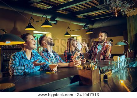 Sport, People, Leisure, Friendship, Entertainment Concept - Happy Male And Female Football Fans Or G