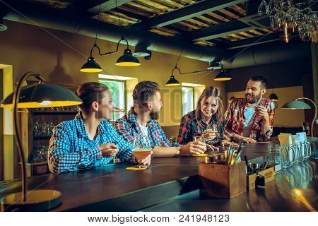 Sport, People, Leisure, Friendship, Entertainment Concept - Happy Male And Female Football Fans Or G