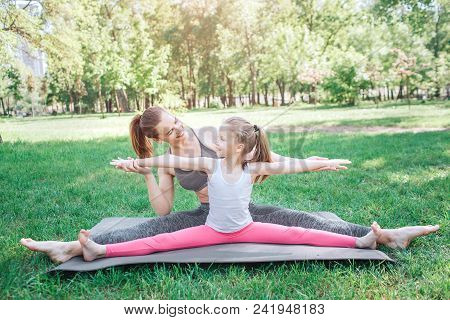 Female Aduld And Kid Are Sitting On Twine Position. It Is Very Easy For Them. Small Girl Is Keeping 