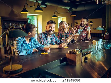 Sport, People, Leisure, Friendship, Entertainment Concept - Happy Male And Female Football Fans Or G
