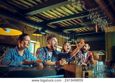 Sport, People, Leisure, Friendship, Entertainment Concept - Happy Male And Female Football Fans Or G