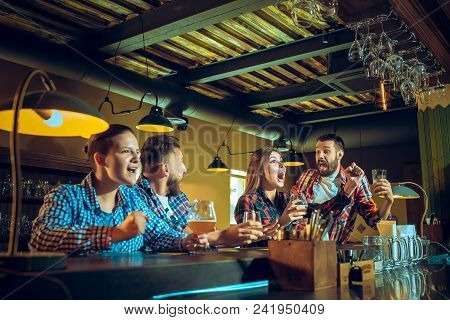 Sport, People, Leisure, Friendship, Entertainment Concept - Happy Male And Female Football Fans Or G