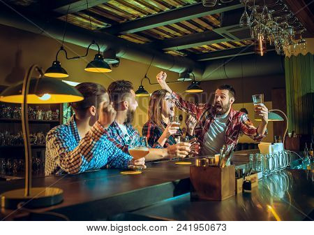 Sport, People, Leisure, Friendship, Entertainment Concept - Happy Male And Female Football Fans Or G