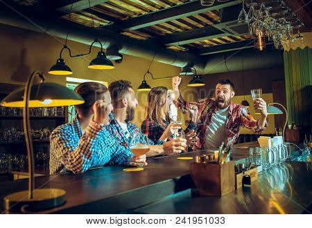 Sport, People, Leisure, Friendship, Entertainment Concept - Happy Male And Female Football Fans Or G