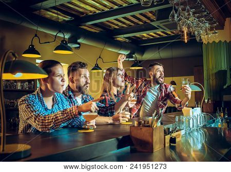 Sport, People, Leisure, Friendship, Entertainment Concept - Happy Male And Female Football Fans Or G