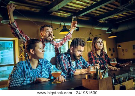 Sport, People, Leisure, Friendship, Entertainment Concept - Happy Male And Female Football Fans Or G