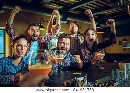 Sport, People, Leisure, Friendship, Entertainment Concept - Happy Male And Female Football Fans Or G