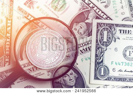 Shiny Golden Augur Cryptocurrency Coin On Blurry Background With Dollar Money Token