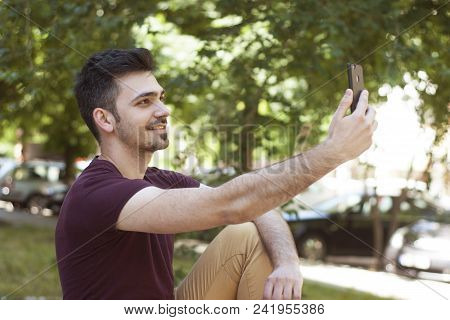 Young Man Portret Close Up Smiling Outdoors Portraitholding Mobile Phone Selfie Photo Copy Space Blu