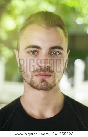 Young Man Portret Smiling Outdoors Portrait Looking At Camera Blurred Park Background Copy Space