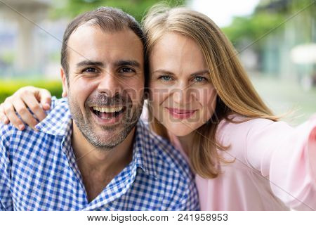Self Portrait Of Cheerful Modern Couple In Love. Male And Female Tourists Enjoying Their Vacation. L