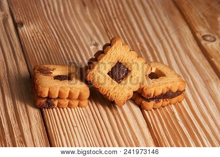 Warm Homemade Gingersnap Cookies Topped With Chocolate On Wooden Table