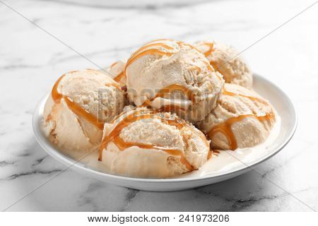 Tasty Ice Cream With Caramel Sauce On Plate