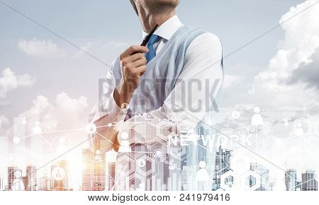 Double Exposure Of Confident And Young Businessman In Smart-casual Wear Smoking Pipe And Modern City