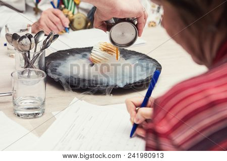 Tasting and evaluation of food by a certified specialist. A professional taster assesses the dessert