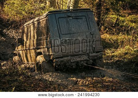Ofroad For Hard Man. Off Road Car Going Through Mud In Forest. Suv Stuck On Country Road With Nature