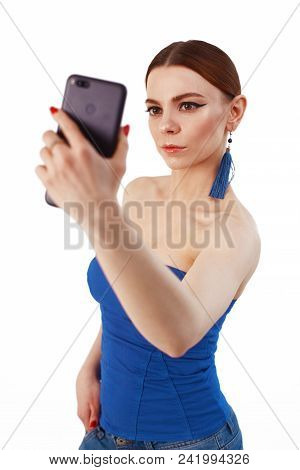 Full Length Portrait Of A Cheerful Smiling Woman Taking Selfie