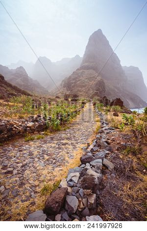 Cobbled Hiking Path To Ponta Do Sol Over Amazing Arid Aranhas Valley With Huge Mountain Peak And Hou
