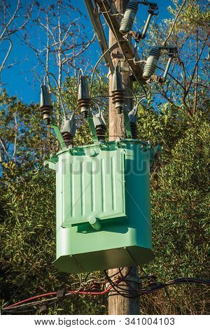 Detail Of High-voltage Power Pole Transformer With Electrical Wiring In Front Of Trees Near Gramado.