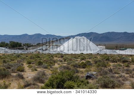Converyor Belt Piling Up Heaps Of White Powder In The Desert