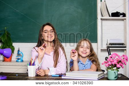 Play And Learn On September 1. Happy Small Child And Teacher Hold Markers On September 1. Little Pup