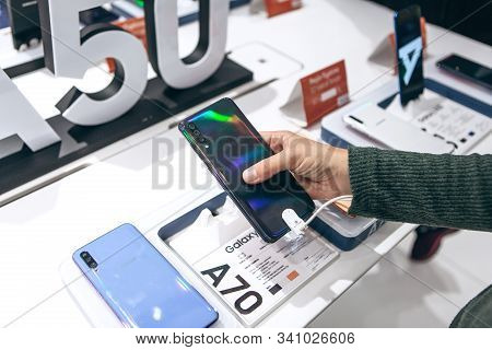 Turkey, Istanbul, December 20, 2019: The Buyer Takes A New Modern Samsung Phone And Wants To Buy It.