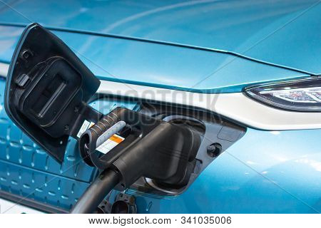 Charging An Electric Or Hybrid Phev Car With The Power Cable Supply Plugged In. Electric Car Chargin