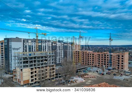Construction Site Background. Hoisting Cranes And New Multi-storey Buildings. I.ndustrial Background