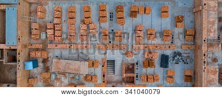 Pallets Of Clay Brick Stored For Building Construction. Construction Site Background. Top View, Ndus