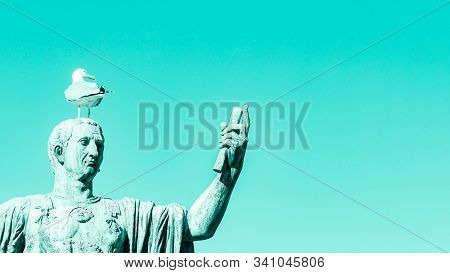 Statue Of Emperor With Gull On The Head. Man Taking Selfie. Humor Concept. Mint Aqua Menthe Color Ba