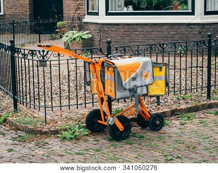 Haarlem, Netherlands - Aug 18, 2018: Orange Mail Transportation Carriage Device Used By Post Nl Mail