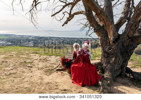Santa And Mrs Claus Posed On Hilltop With Christmas Sign During First Annual Hike With Santa Event B