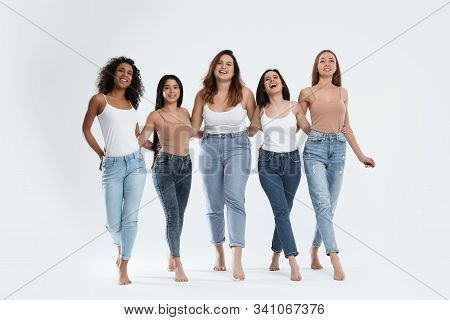 Group Of Women With Different Body Types On Light Background