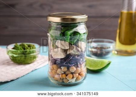 Glass Jar With Healthy Meal On Light Blue Wooden Table