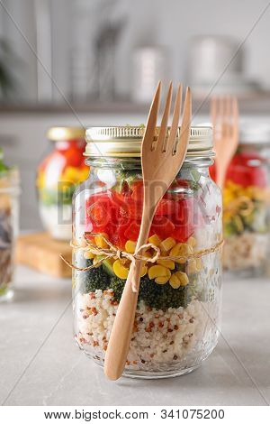 Glass Jar With Healthy Meal On Light Grey Marble Table