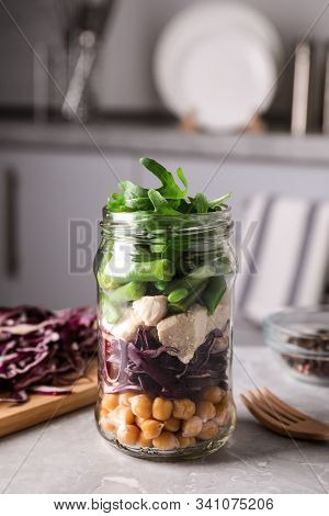 Glass Jar With Healthy Meal On Light Grey Marble Table