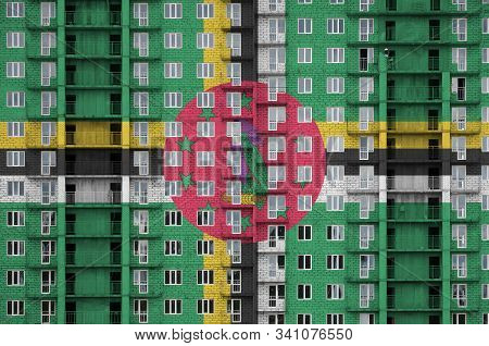 Dominica Flag Depicted In Paint Colors On Multi-storey Residental Building Under Construction. Textu