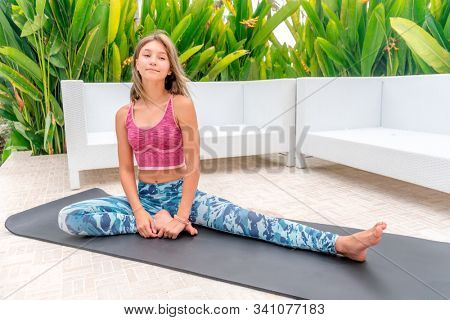 Teanage girl stretching in a garden
