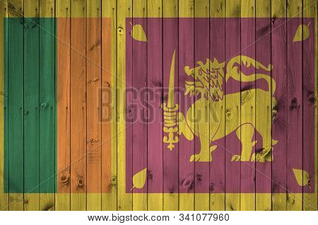 Sri Lanka Flag Depicted In Bright Paint Colors On Old Wooden Wall. Textured Banner On Rough Backgrou