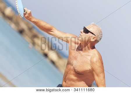 Adult Male Playing Matkot On The Beach
