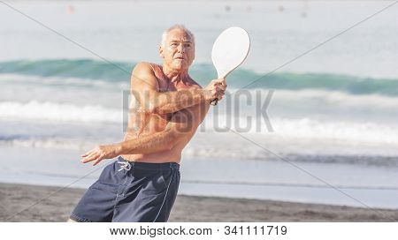 Adult Male Playing Matkot On The Beach